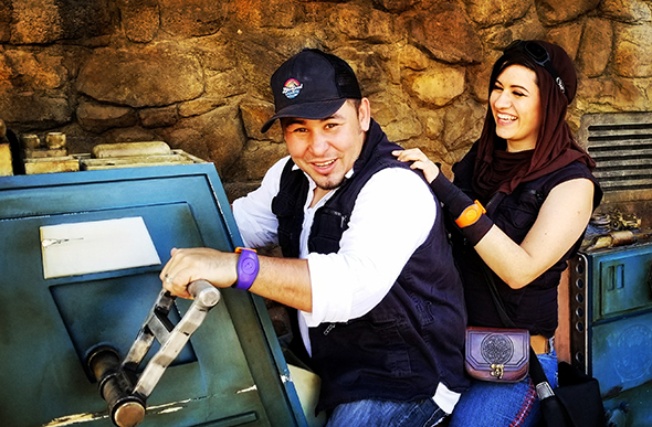 A pair of casual Disneybounders laughing it up on a speeder